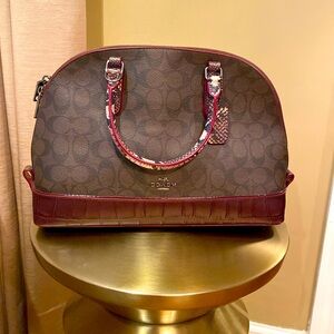 Coach burgundy and brown color.